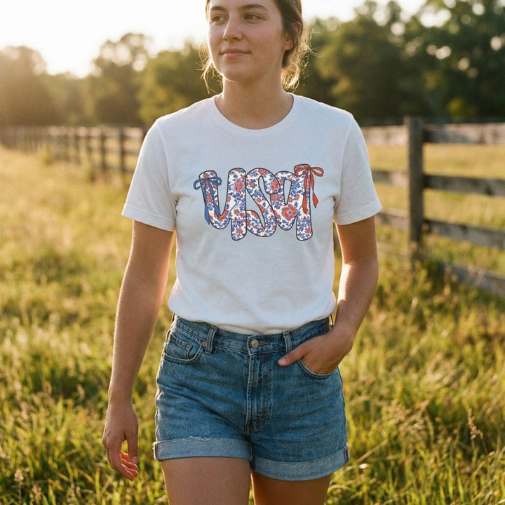 Rockledge Designs LLC Shirts & Tops Floral Coquette USA Tee – Patriotic Vintage Bow Graphic T-Shirt for 4th of July - WE503 Floral Coquette USA Tee – Patriotic Vintage Bow Graphic T-Shirt for 4th of July - WE503
