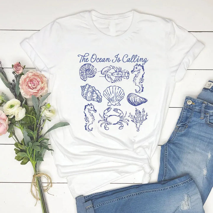 Rockledge Designs LLC Shirts & Tops The Ocean Is Calling Graphic Tee – Coastal Seashell Shirt – Beach Lover Nautical T-Shirt - SE119 The Ocean Is Calling Graphic Tee – Coastal Seashell Shirt – Beach Lover Nautical T-Shirt - SE119